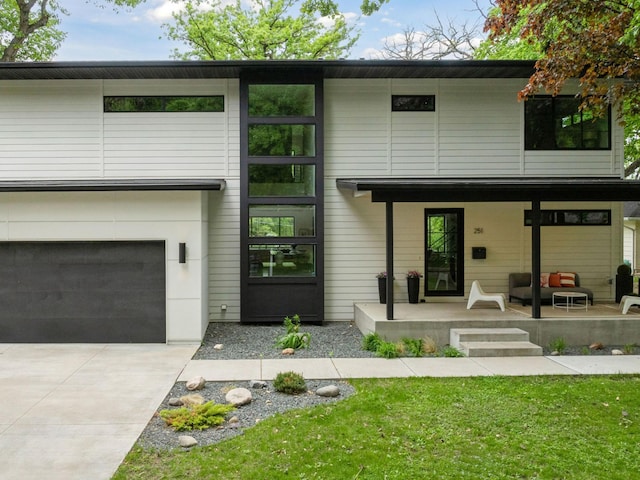 251 Glenbrook Rd N, Wayzata, MN 55391 - modern home with concrete driveway, a garage, and a front lawn