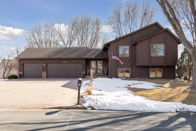 1001 Gramsey Pl, Burnsville, MN 55306 - tri-level home with an attached garage and decorative driveway
