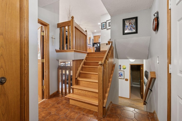 1001 Gramsey Pl, Burnsville, MN 55306 - staircase with a textured ceiling, recessed lighting, tile patterned flooring, and baseboards