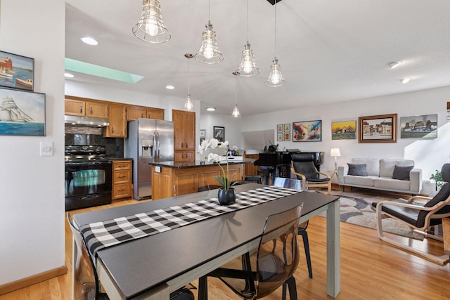 1001 Gramsey Pl, Burnsville, MN 55306 - dining area with light wood-style flooring, a skylight, recessed lighting, and baseboards