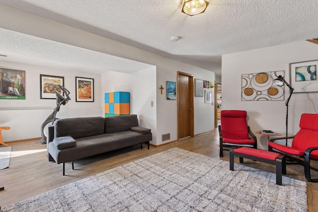 1001 Gramsey Pl, Burnsville, MN 55306 - living room with wood finished floors, a textured ceiling, and baseboards