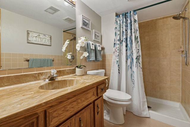 1001 Gramsey Pl, Burnsville, MN 55306 - bathroom featuring tile walls, a shower stall, toilet, tile patterned flooring, and vanity