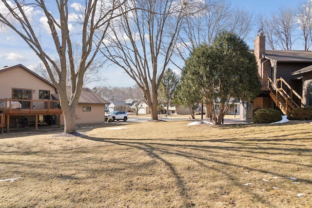 1001 Gramsey Pl, Burnsville, MN 55306 - view of grassy yard featuring a deck, stairway, and a residential view