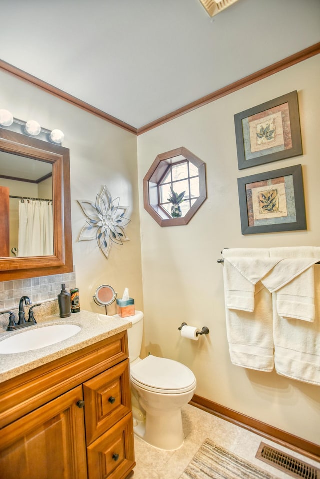 bathroom featuring crown molding, visible vents, vanity, toilet, and tile patterned floors
