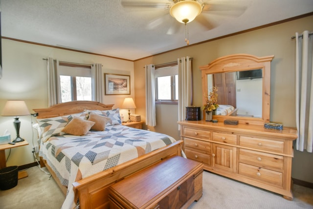 bedroom featuring crown molding, baseboards, a ceiling fan, and light colored carpet