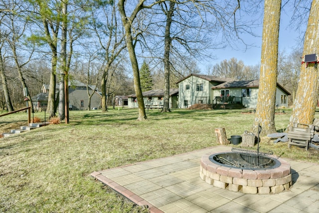 view of yard featuring an outdoor fire pit and a patio area