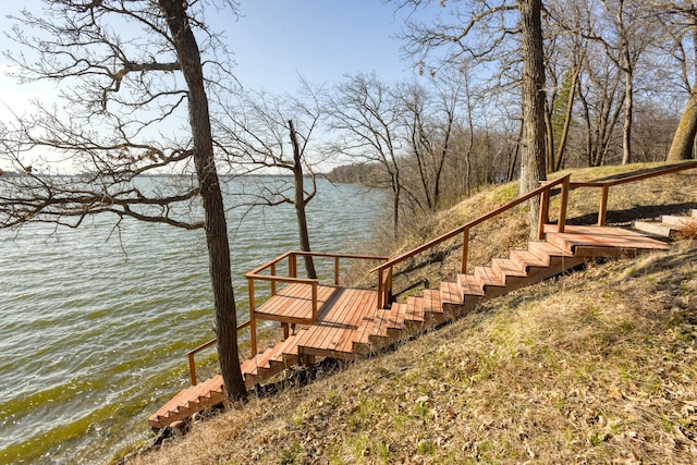 view of dock featuring a water view and stairway