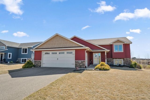 view of front of home featuring a garage, a front yard, driveway, and stone siding