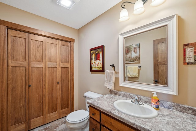 bathroom featuring toilet and vanity