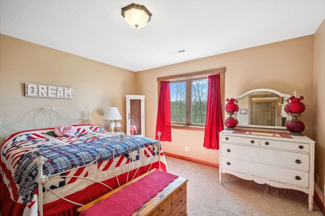 carpeted bedroom featuring visible vents and baseboards