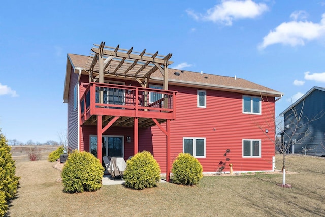 rear view of house with a deck, a lawn, and a pergola