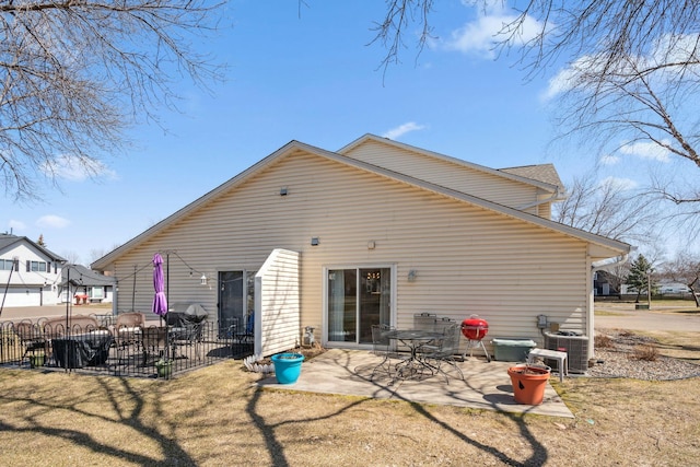 rear view of property featuring central AC, fence, a yard, and a patio