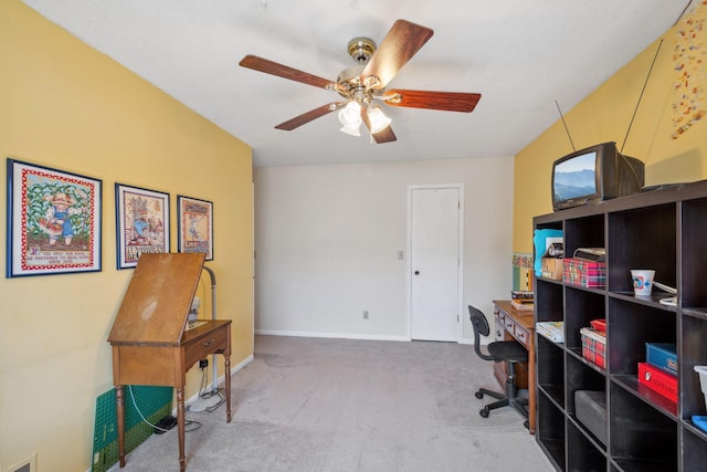 carpeted office space featuring baseboards, a ceiling fan, and visible vents