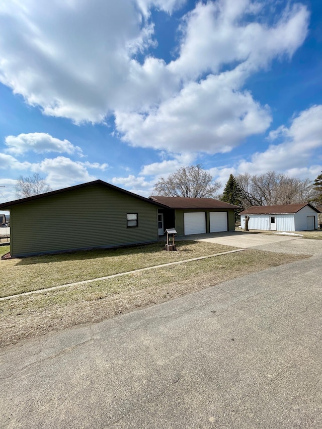 ranch-style house with a garage and concrete driveway
