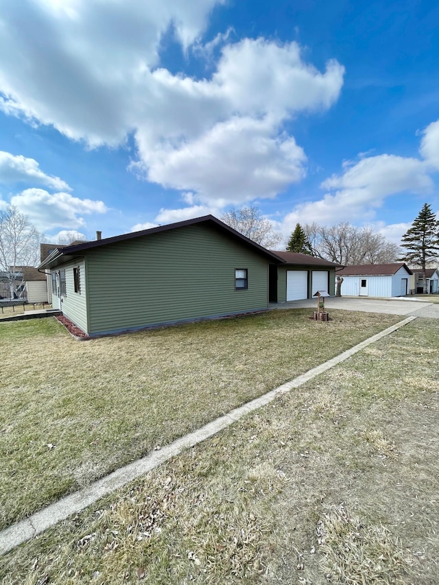view of side of property featuring an attached garage and concrete driveway