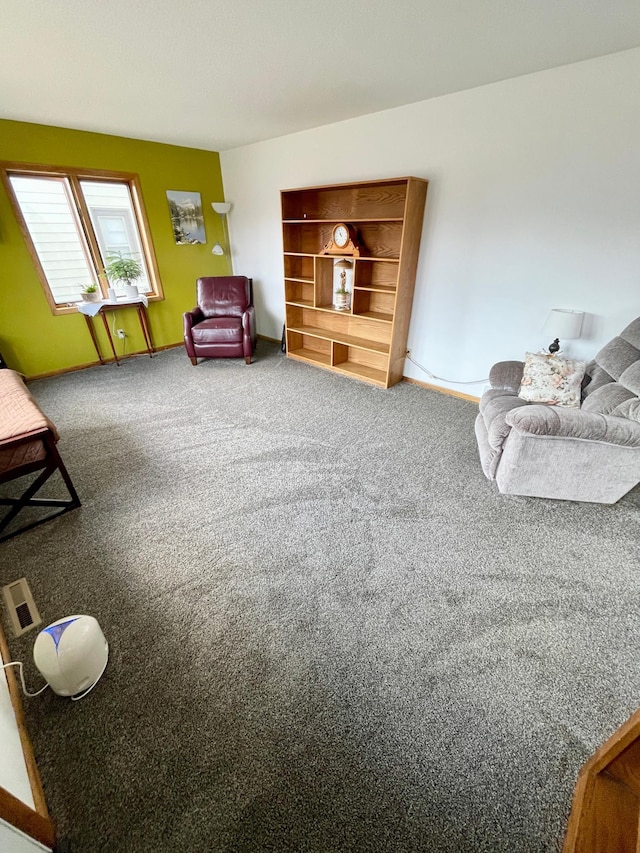sitting room with baseboards and carpet floors