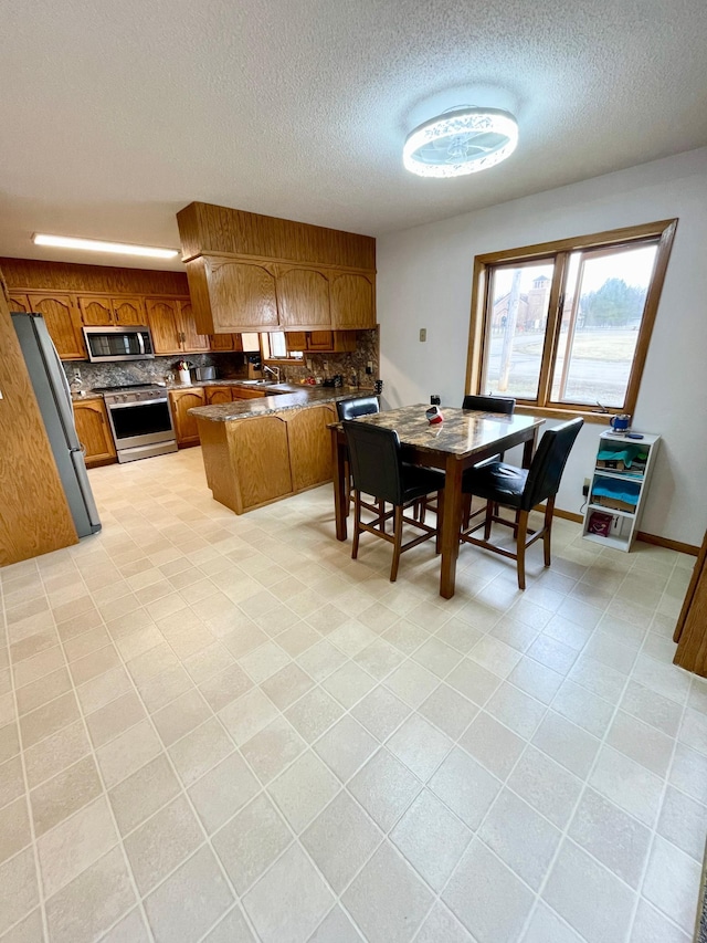 dining space with light tile patterned floors and a textured ceiling