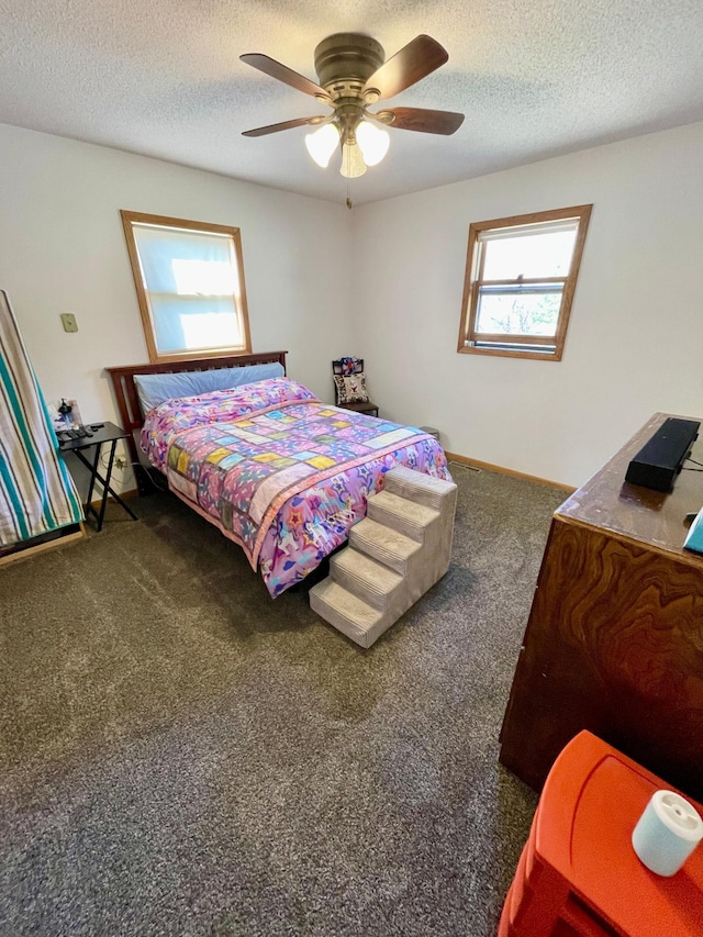 carpeted bedroom with a textured ceiling and a ceiling fan