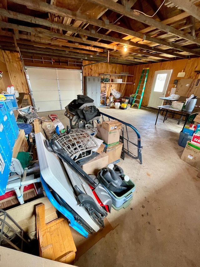 garage featuring wood walls