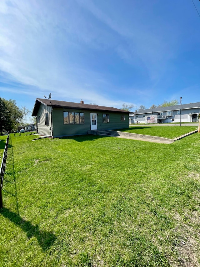 123 3rd St, Bluffton, MN 56518 - back of property featuring fence and a lawn
