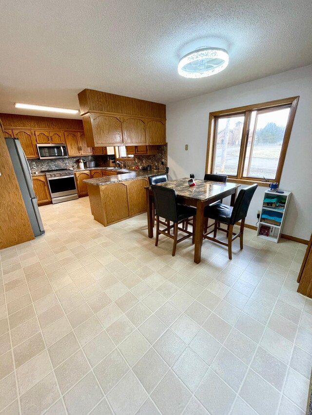 123 3rd St, Bluffton, MN 56518 - dining space with a textured ceiling and light tile patterned flooring