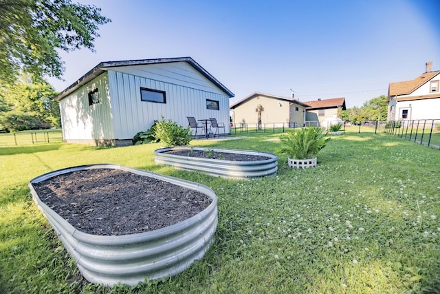 123 3rd St, Bluffton, MN 56518 - rear view of house featuring board and batten siding, a vegetable garden, and a fenced backyard