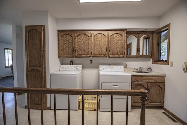 123 3rd St, Bluffton, MN 56518 - laundry room with cabinet space, washing machine and dryer, and light tile patterned floors