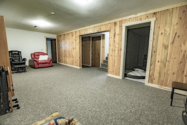 123 3rd St, Bluffton, MN 56518 - living area featuring wooden walls, carpet floors, a textured ceiling, and stairway