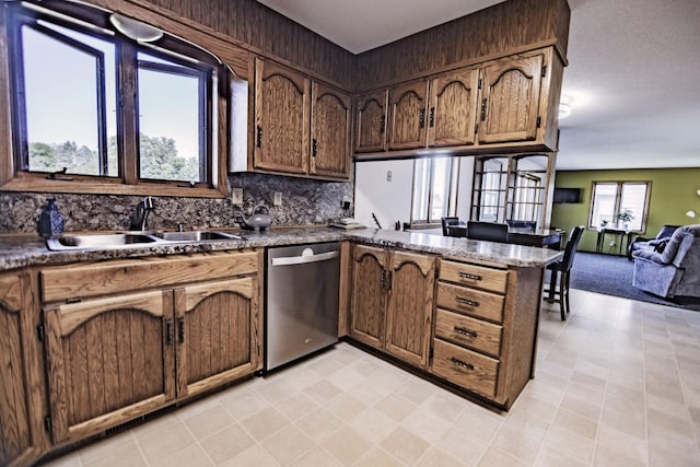 123 3rd St, Bluffton, MN 56518 - kitchen featuring dishwasher, a peninsula, dark countertops, decorative backsplash, and open floor plan
