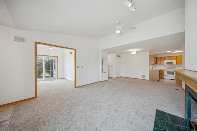 2786 87th St E Unit 18, Inver Grove Heights, MN 55076 - unfurnished living room featuring light carpet, a ceiling fan, and baseboards