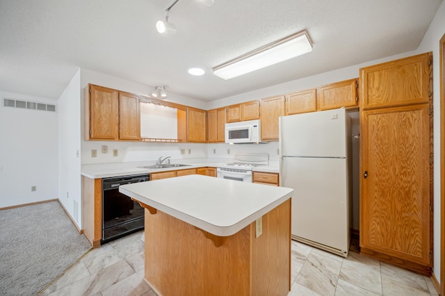 2786 87th St E Unit 18, Inver Grove Heights, MN 55076 - kitchen featuring white appliances, a sink, light countertops, a center island, and baseboards