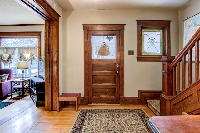 entryway featuring light wood-type flooring and stairs