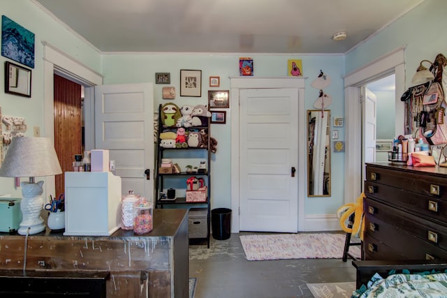 bedroom featuring crown molding and finished concrete flooring