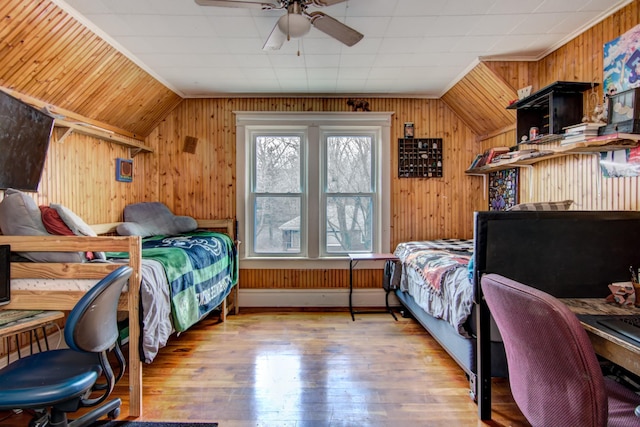 bedroom featuring wooden walls and hardwood / wood-style floors