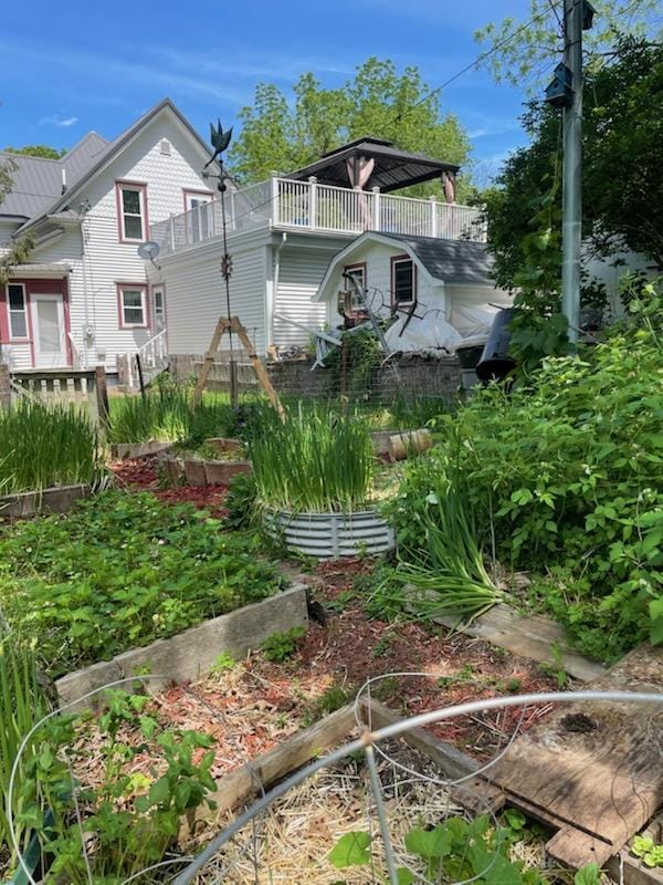 view of yard with a balcony and a garden