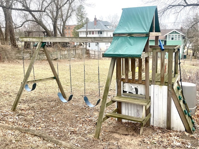 view of playground featuring a yard and fence