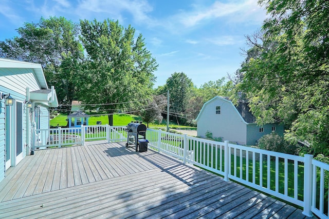 108 1st St, Kenyon, MN 55946 - deck with an outbuilding, a lawn, area for grilling, and view of scattered trees