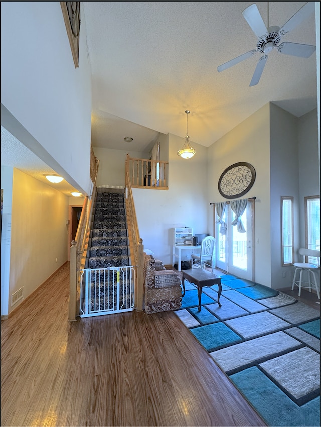 14132 Heywood Path, Apple Valley, MN 55124 - living room with stairway, a textured ceiling, visible vents, ceiling fan, and wood finished floors