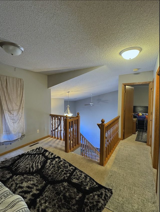 14132 Heywood Path, Apple Valley, MN 55124 - corridor featuring baseboards, an upstairs landing, a textured ceiling, visible vents, and carpet