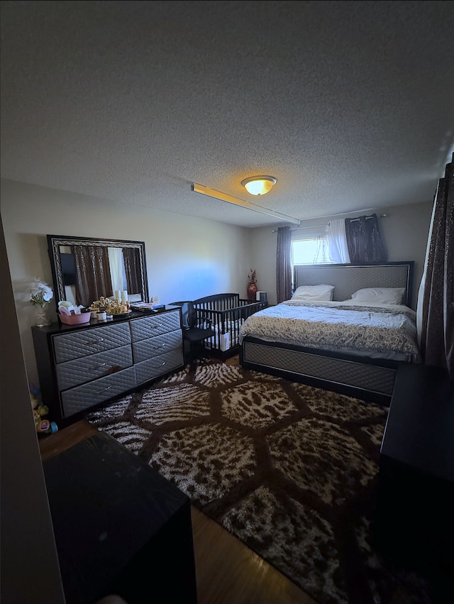 14132 Heywood Path, Apple Valley, MN 55124 - bedroom with wood finished floors and a textured ceiling