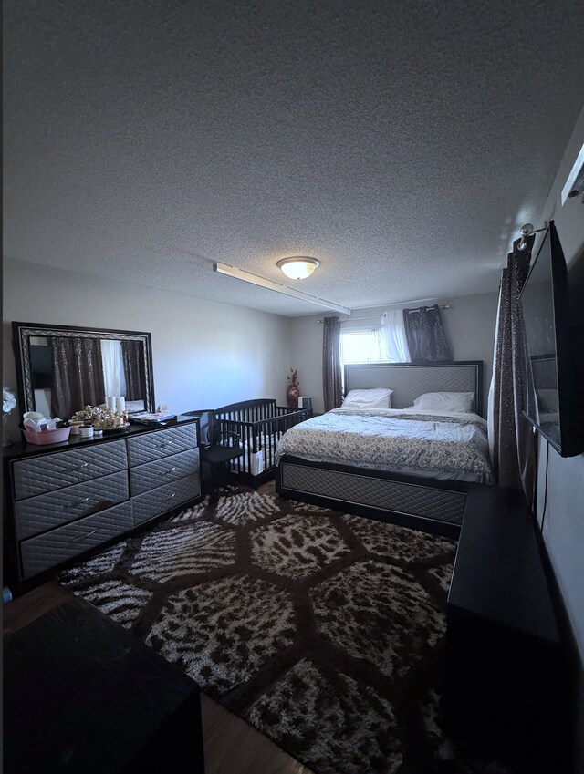 14132 Heywood Path, Apple Valley, MN 55124 - bedroom featuring wood finished floors and a textured ceiling