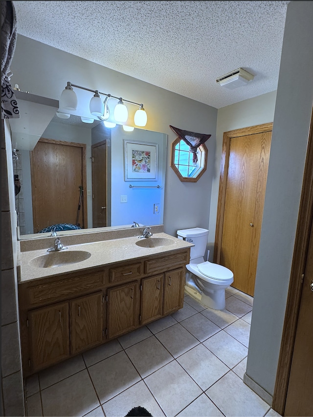 14132 Heywood Path, Apple Valley, MN 55124 - bathroom with a sink, toilet, tile patterned flooring, and a textured ceiling