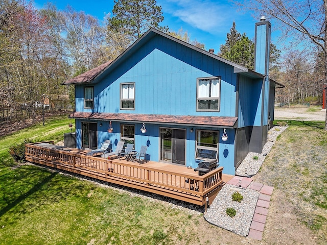 22004 Old Curry Rd SE, Cass Lake, MN 56633 - back of house featuring a chimney, a yard, and a deck