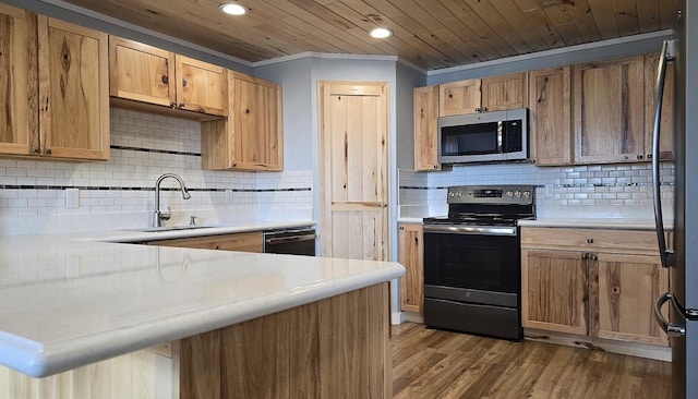 22004 Old Curry Rd SE, Cass Lake, MN 56633 - kitchen featuring stainless steel appliances, a sink, light countertops, backsplash, and recessed lighting