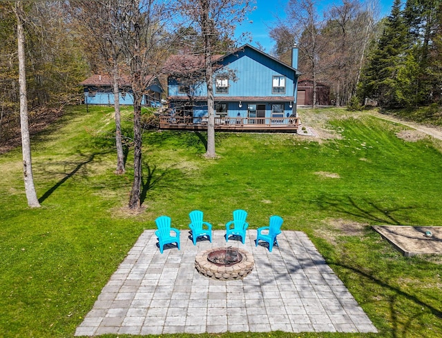 22004 Old Curry Rd SE, Cass Lake, MN 56633 - view of green lawn with an outdoor fire pit, a patio, and a wooden deck