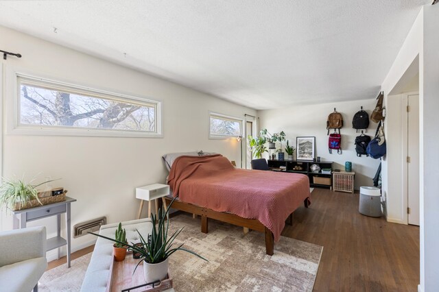 bedroom featuring visible vents and wood finished floors