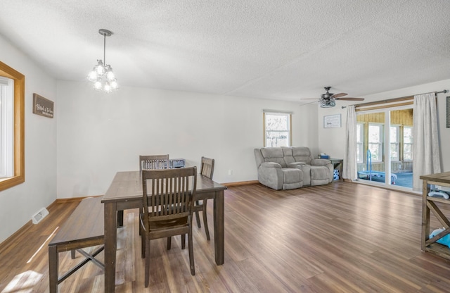 11799 191st Ave NW, Elk River, MN 55330 - dining room featuring a textured ceiling, wood finished floors, a ceiling fan, a chandelier, and baseboards