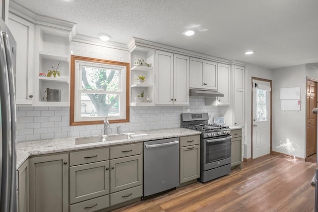 11799 191st Ave NW, Elk River, MN 55330 - kitchen with stainless steel appliances, open shelves, a sink, under cabinet range hood, and healthy amount of natural light