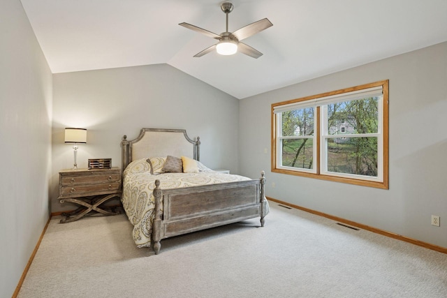 carpeted bedroom with baseboards, ceiling fan, lofted ceiling, and visible vents