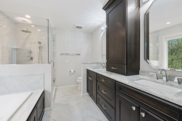 bathroom with a sink, a shower stall, marble finish floor, and visible vents